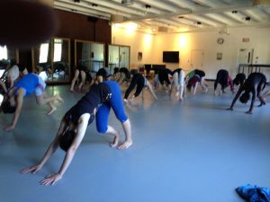 Counselor Laquimah VanDunk leads students through their morning warm-up.