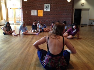 Students gather around their instructor at the start of class.